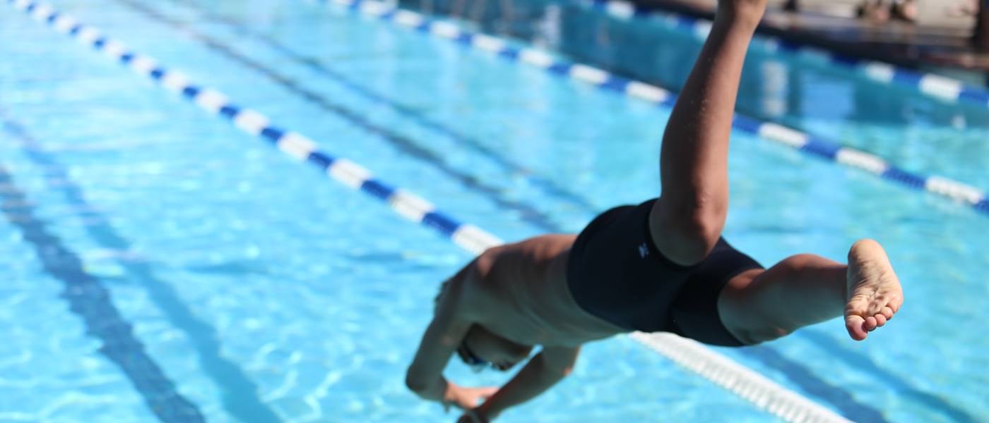 Swimmer diving into a lap pool